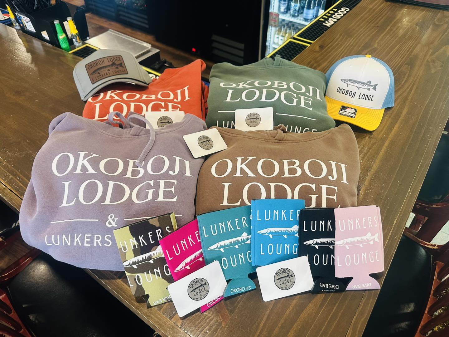 Okoboji Lodge merchandise — sweatshirts, hats, koozies